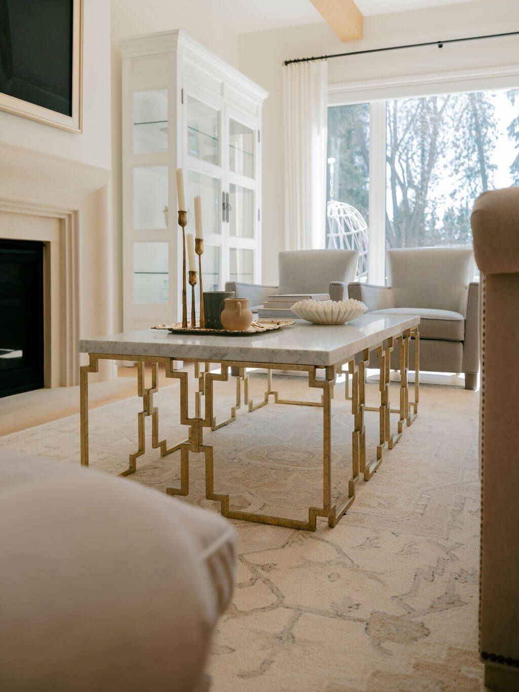 Large window bedroom featuring off white bedding and furniture