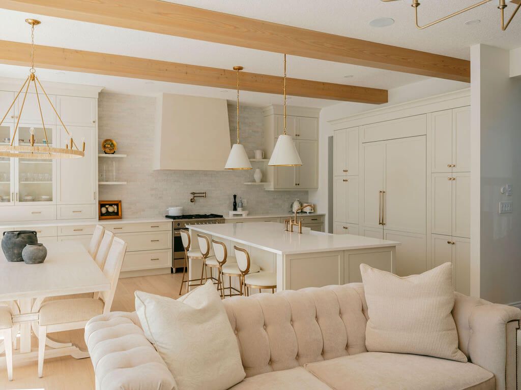 Large window bedroom featuring off white bedding and furniture